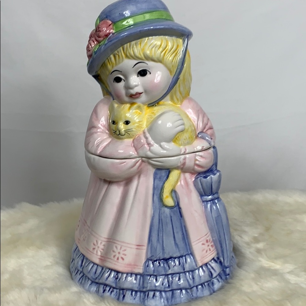 Ceramic cookie jar of girl with a kitten. 12” high